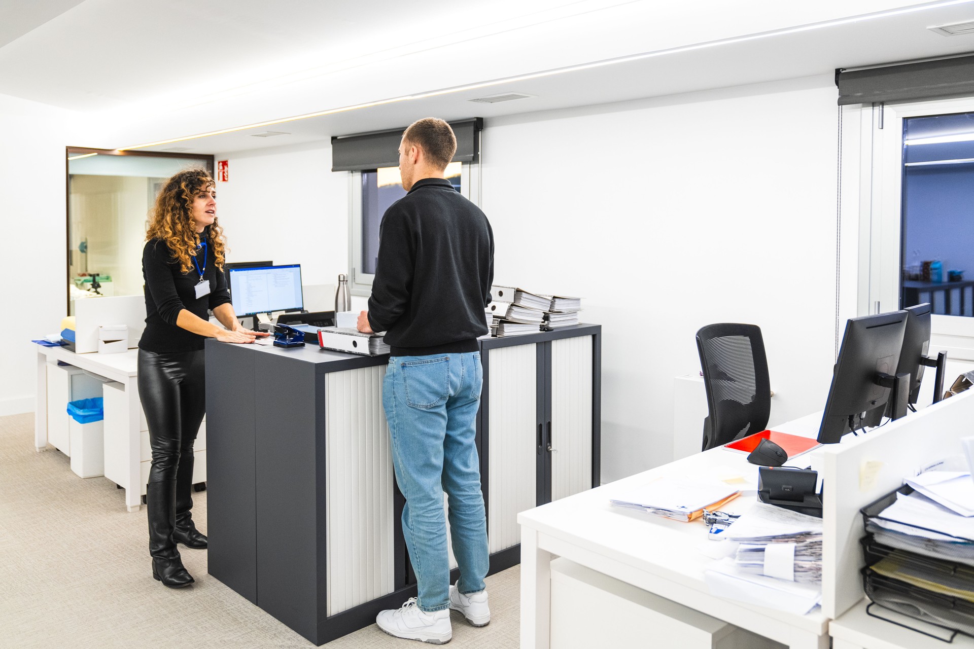 Engaged Employee Communicating with Receptionist at Workplace