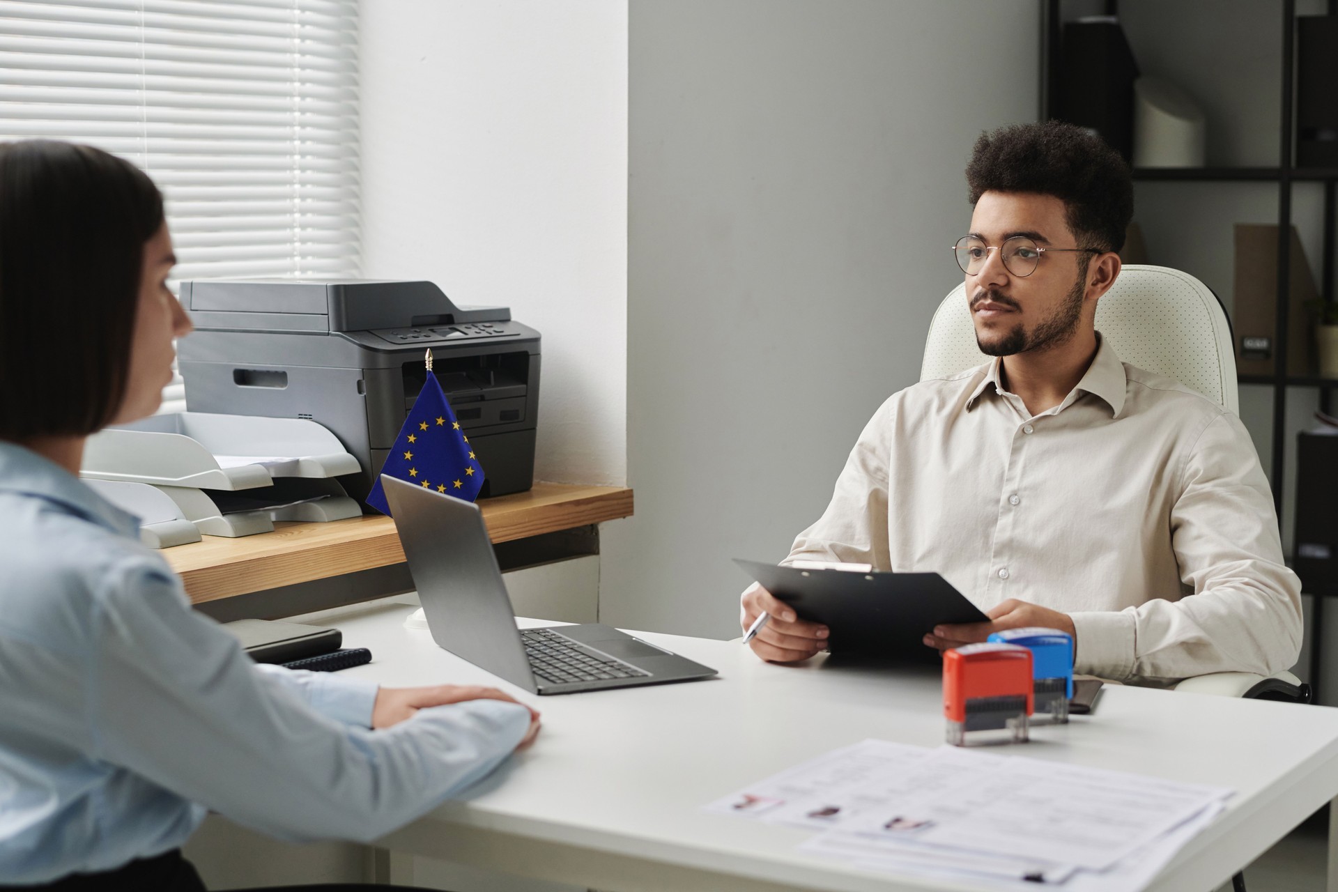 Employee of visa center having interview with applicant