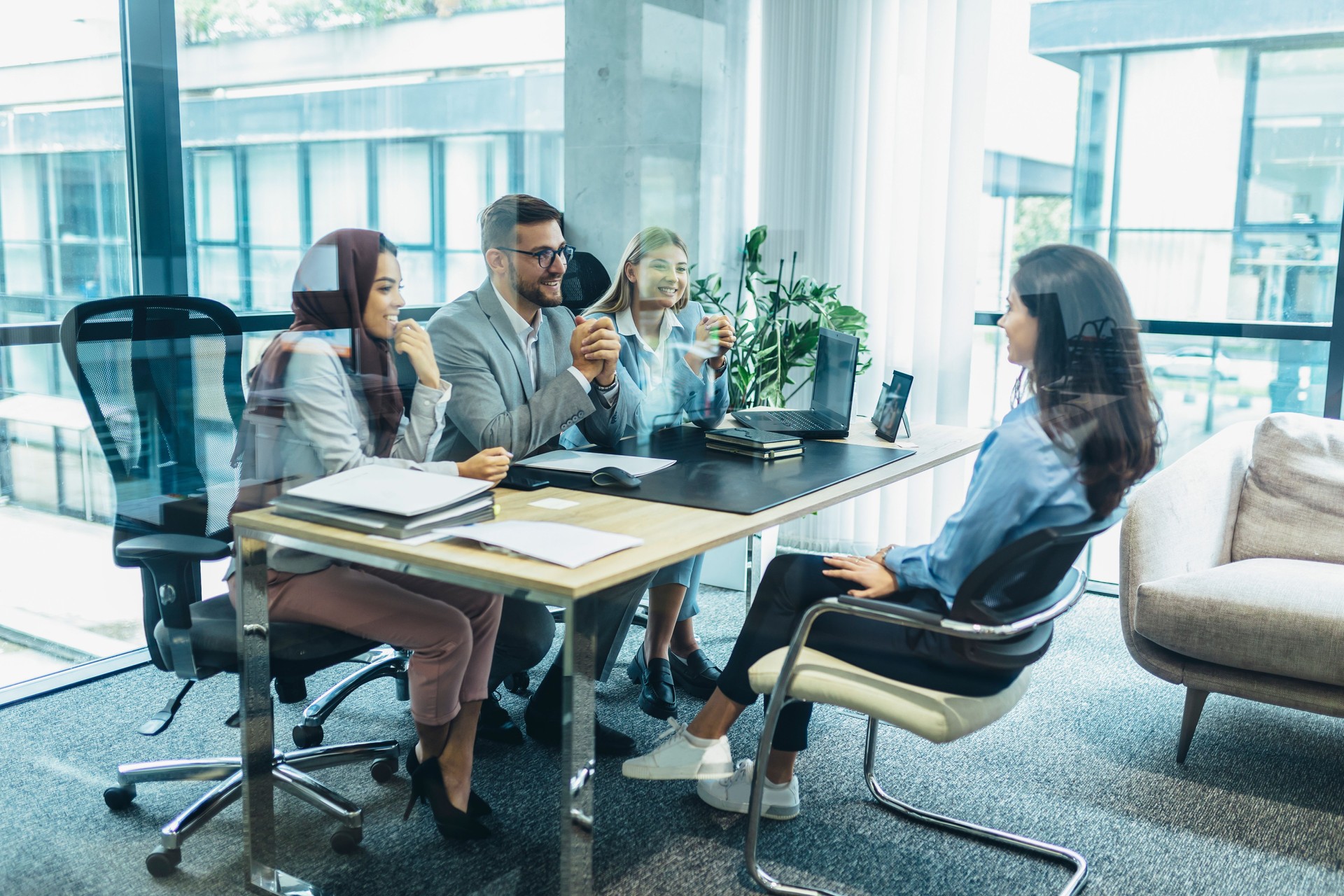 Human resource team talking to a candidate during a job interview in the office.